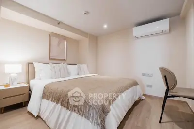 Modern bedroom with cozy decor and air conditioning in a stylish apartment.