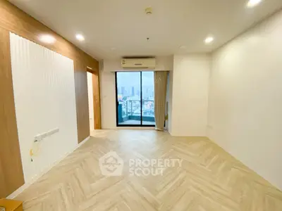 Spacious modern living room with city view and elegant wooden flooring.