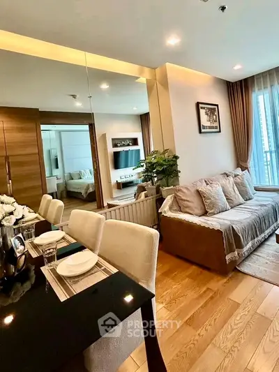Modern living room with elegant decor and dining area in a stylish apartment.