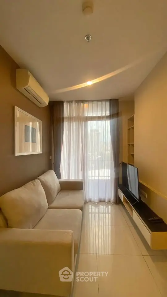 Cozy living room with modern sofa and large window for natural light