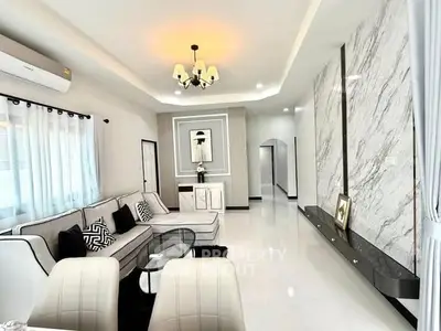 Elegant modern living room with stylish decor and marble accent wall