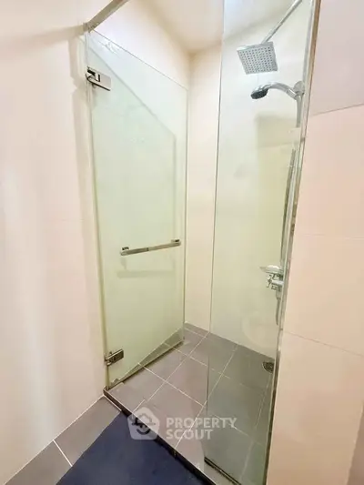 Modern bathroom with glass shower enclosure and sleek fixtures