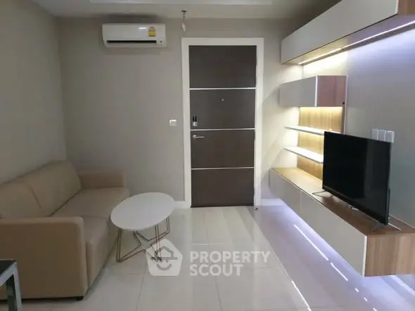 Modern living room with sleek furniture and wall-mounted TV unit