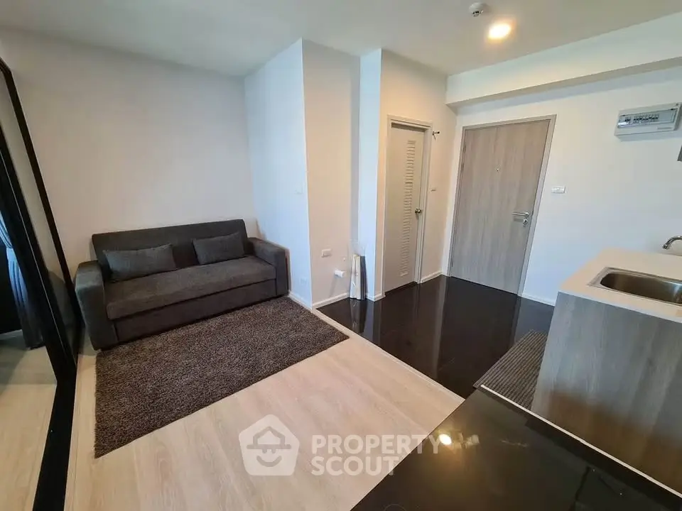Modern living room with sleek design and cozy sofa in a stylish apartment.
