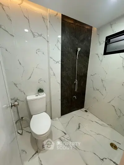 Modern bathroom with marble tiles and sleek shower design