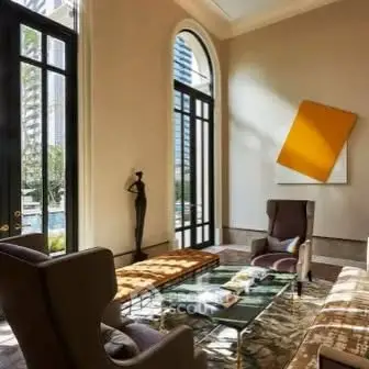 Luxurious living room with high ceilings and modern decor in upscale apartment.