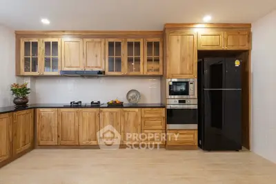 Spacious kitchen with wooden cabinets and modern appliances