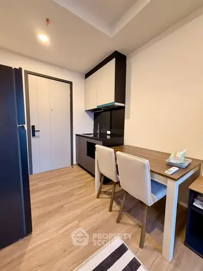 Modern compact kitchen with dining area in a stylish apartment