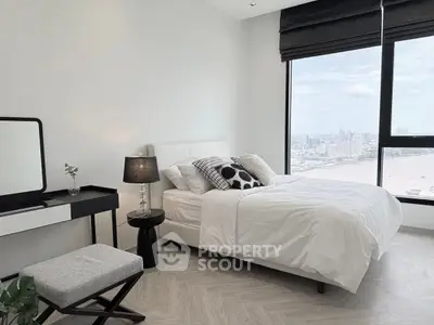 Modern bedroom with city view, featuring stylish decor and large windows for natural light.