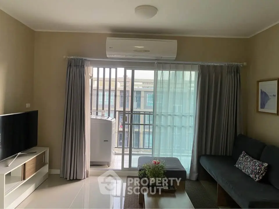 Modern living room with balcony, air conditioning, and stylish decor