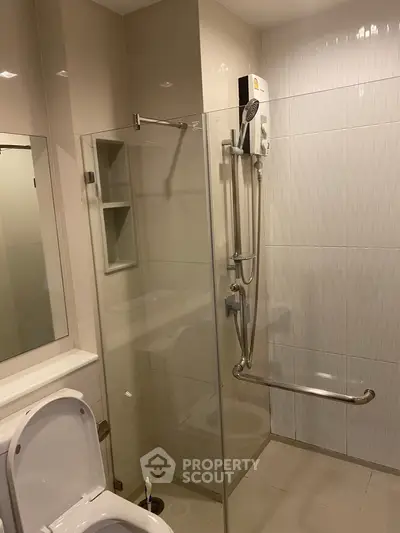 Modern bathroom with glass shower enclosure and sleek fixtures