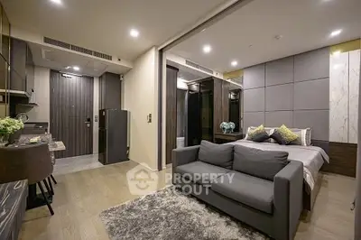 Modern studio apartment with open layout, featuring a cozy living area and stylish bedroom.