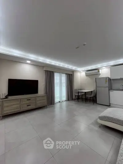 Modern living room with sleek furniture and open kitchen layout