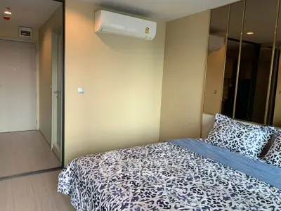 Modern bedroom with stylish bedding and mirrored closet doors