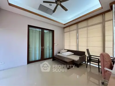 Spacious modern living room with ceiling fan and large windows