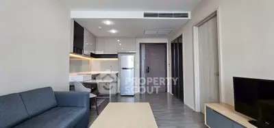 Modern living room with sleek furniture and open kitchen layout