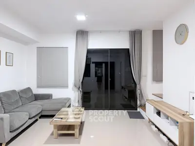 Modern living room with sleek furniture and large window view