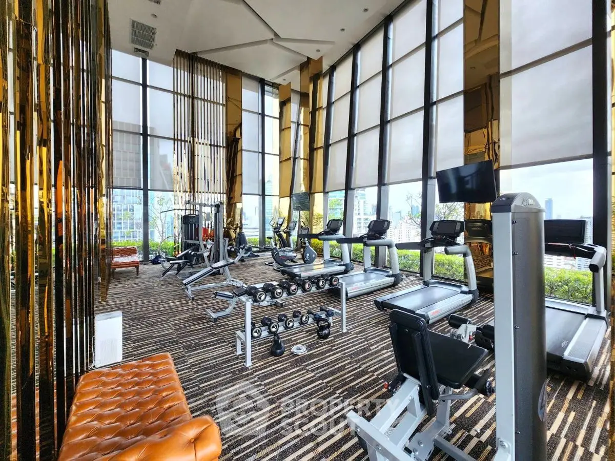 Luxurious high-rise gym with panoramic city views and modern fitness equipment.