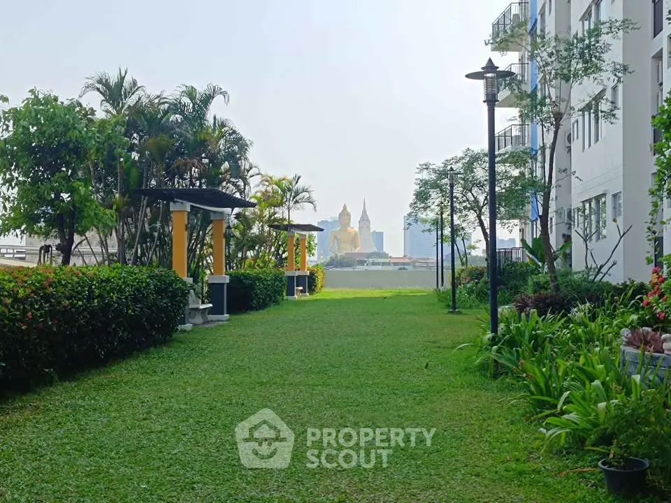 Lush garden view with cityscape backdrop in modern residential complex