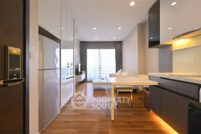 Modern open-plan kitchen and living area with sleek design and natural light.