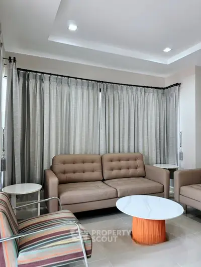 Modern living room with stylish furniture and elegant curtains, perfect for a cozy and inviting atmosphere.