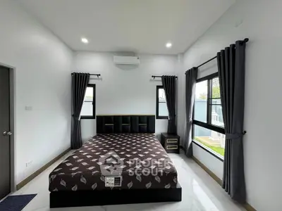 Spacious modern bedroom with large windows and stylish decor