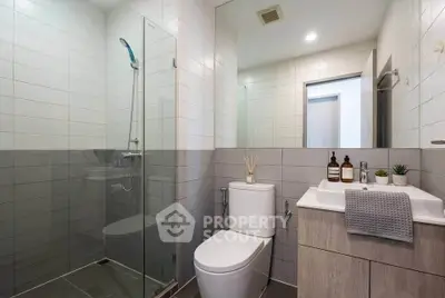 Modern bathroom with sleek design, glass shower, and stylish fixtures.
