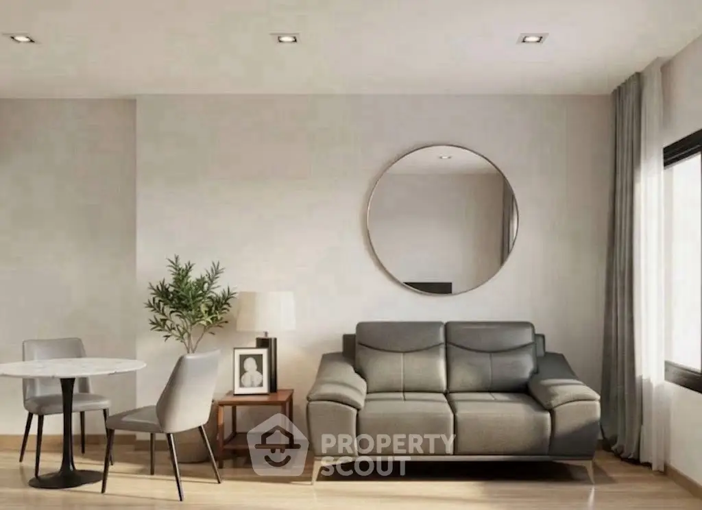 Modern living room with stylish furniture and large round mirror, perfect for contemporary living.