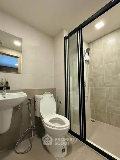 Modern bathroom with sleek shower enclosure and contemporary fixtures.
