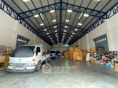 Spacious warehouse interior with high ceilings and ample storage space.