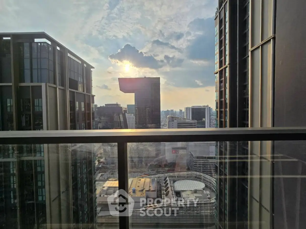 Stunning cityscape view from a modern high-rise balcony at sunset.