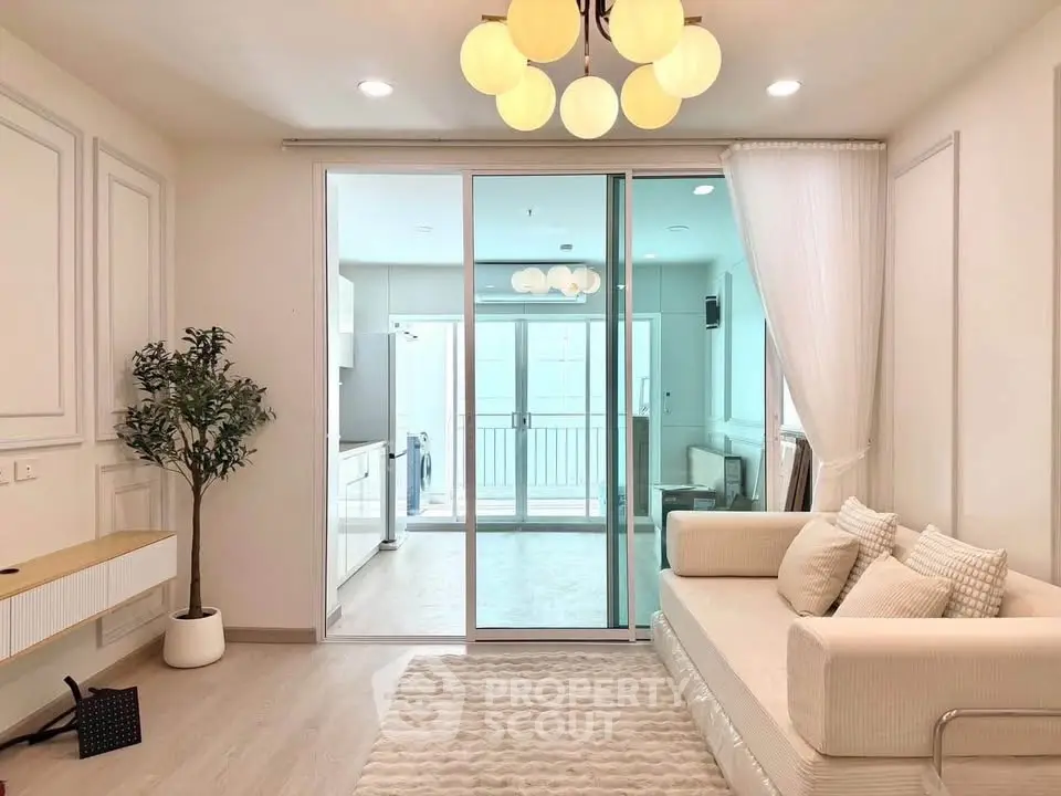 Elegant living room with modern decor and sliding glass doors leading to a bright balcony.