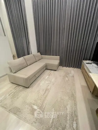 Modern living room with elegant gray curtains and cozy beige sofa