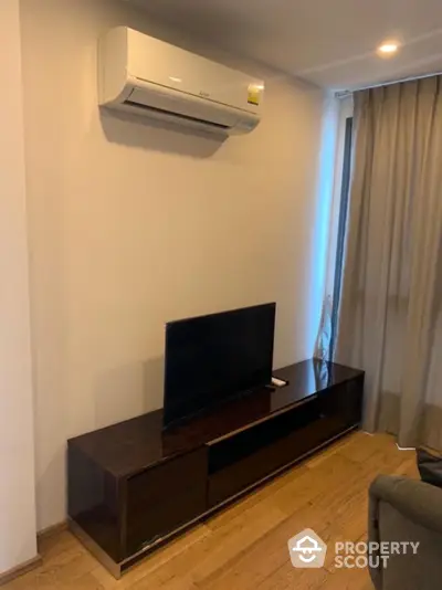 Modern living room with air conditioning and sleek TV setup