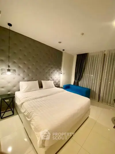Luxurious modern bedroom with plush headboard and elegant lighting