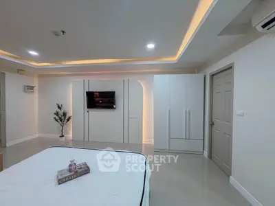 Modern bedroom with sleek design and ambient lighting