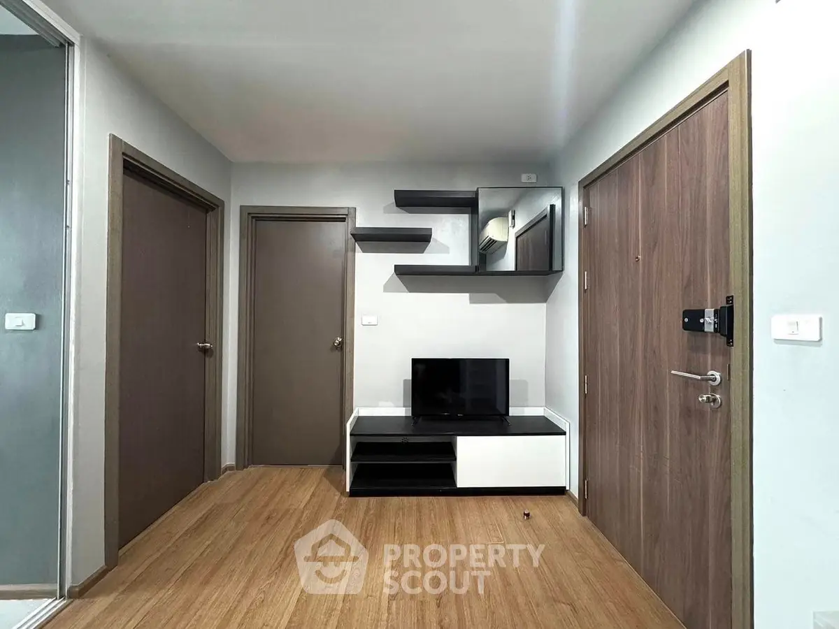 Modern living room with sleek wooden flooring and stylish TV unit