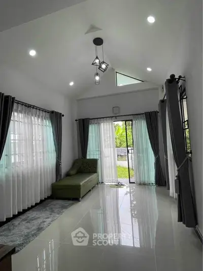 Spacious living room with modern design and large windows for natural light.