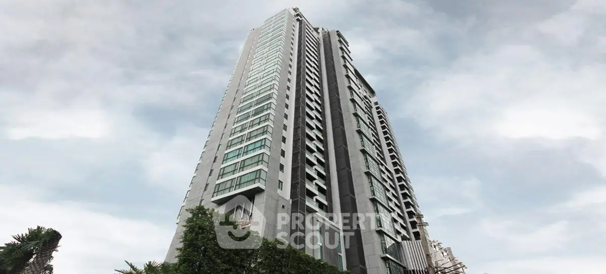 Stunning high-rise building with modern architecture and lush greenery, perfect for urban living.