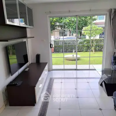 Spacious living room with garden view and modern entertainment setup