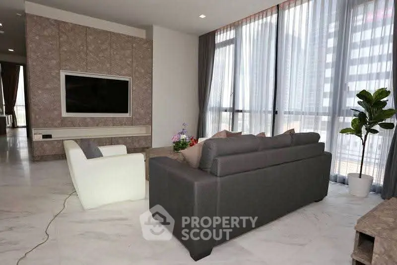 Spacious modern living room with large windows and stylish furniture