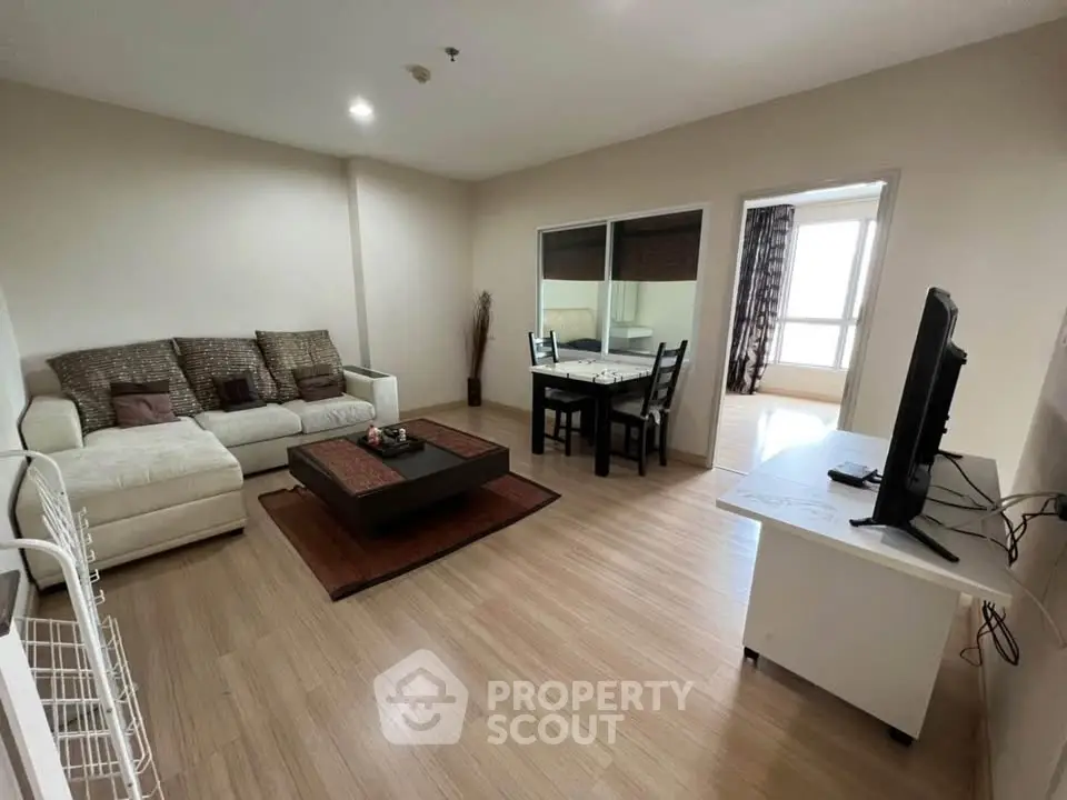 Spacious living room with modern decor and natural light in a stylish apartment.
