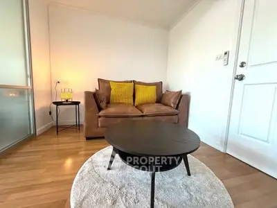 Cozy living room with brown leather sofa and modern coffee table