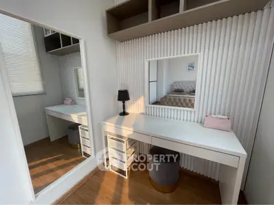 Stylish modern bedroom with elegant vanity and mirror, perfect for a chic and functional living space.
