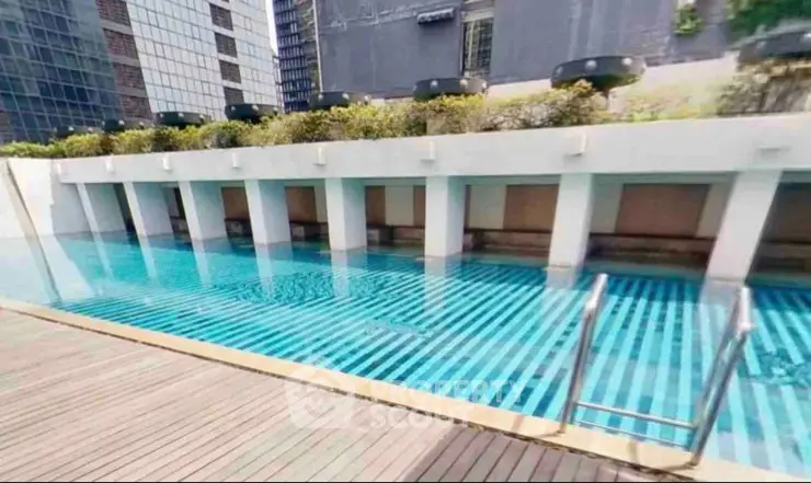 Luxurious rooftop pool with cityscape views in modern high-rise building.