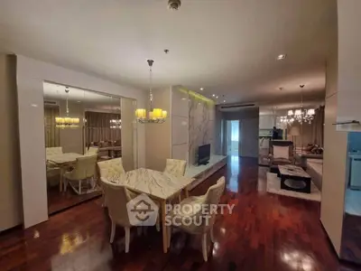 Luxurious open-plan living and dining area with elegant decor and hardwood floors