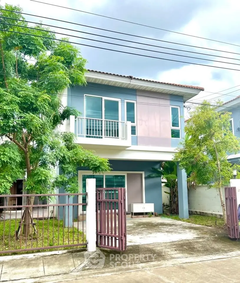 Charming two-story house with modern design and lush greenery in a peaceful neighborhood.