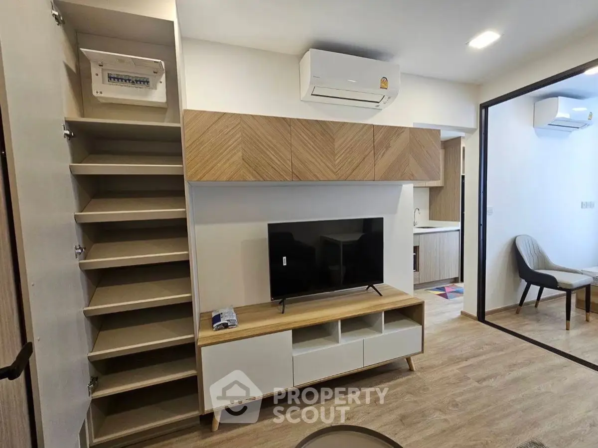 Modern living room with sleek TV stand and air conditioning in stylish apartment.