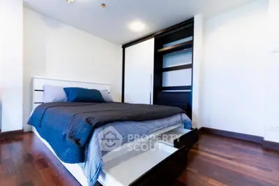 Modern bedroom with sleek storage bed and wooden flooring