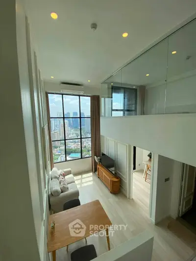 Stunning loft apartment with floor-to-ceiling windows and city view, featuring modern living area and mezzanine.